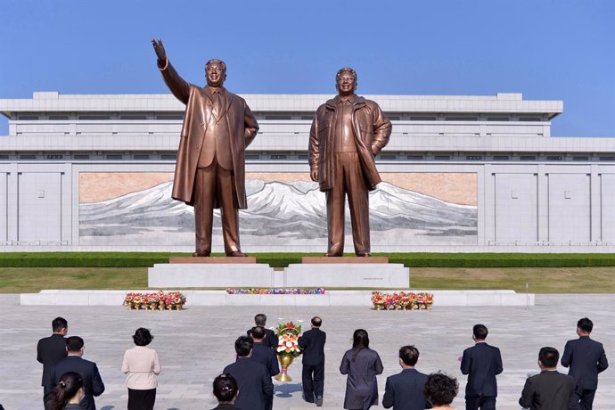 26 April 2021, North Korea, Pyongyang: North Koreans offer flowers in front of the statues of late North Korea founder Kim Il-sung and his late son Kim Jong-il in Pyongyang on the occasion of the 89th founding anniversary of the Korean People's Army. Ph