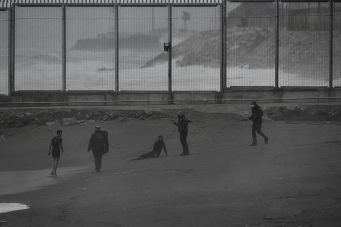 Dos jóvenes migrantes marroquíes han llegado a la playa del Tarajal después de salir a nado desde la ciudad marroquí de Castillejos, a 24 de abril de 2021, en Ceuta.