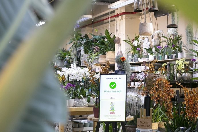 Una pantalla muestra en control de aforo en la floristería Navarro, donde se ha instaurado la prueba piloto BCNRetailLab.