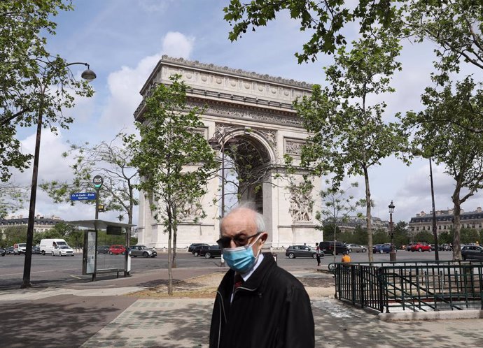 Un hombre camina por los alrededores del Arco del Triunfo, en París.