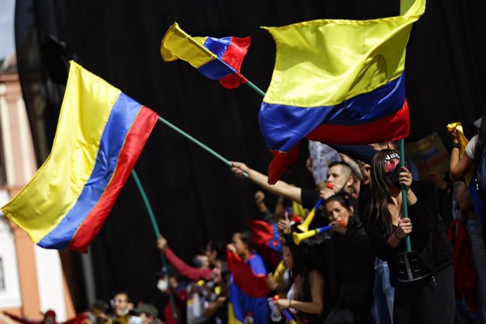 12 May 2021, Colombia, Bogota: Demonstrators wave Colombian flags during a protest against the government of Colombian President Ivan Duque Marquez. Photo: Sergio Acero/colprensa/dpa