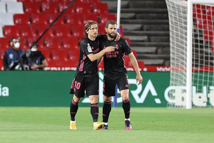 13 May 2021, Spain, Granada: Real Madrid's Luka Modric celebrates scoring his side's first goal with teammate Nacho during the Spanish Primera Division soccer match between Granada FC and Real Madrid CF at the Nuevo Los Carmenes stadium. Photo: Jose Lui