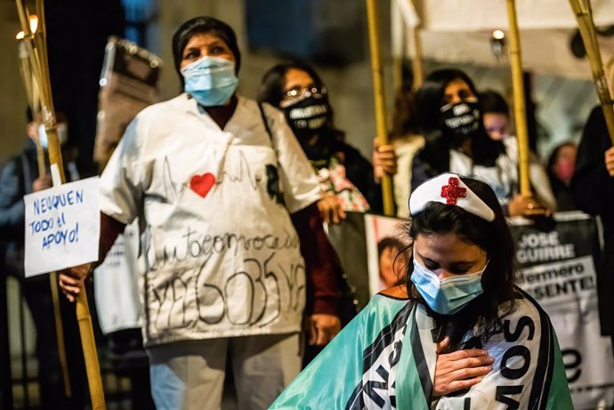 12 May 2021, Argentina, Buenos Aires: Nurses take part in a protest in front of the National Congress demanding better working conditions and remembering their colleagues who died from coronavirus (Covid-19), on the International Nurses' Day. Photo: Ale
