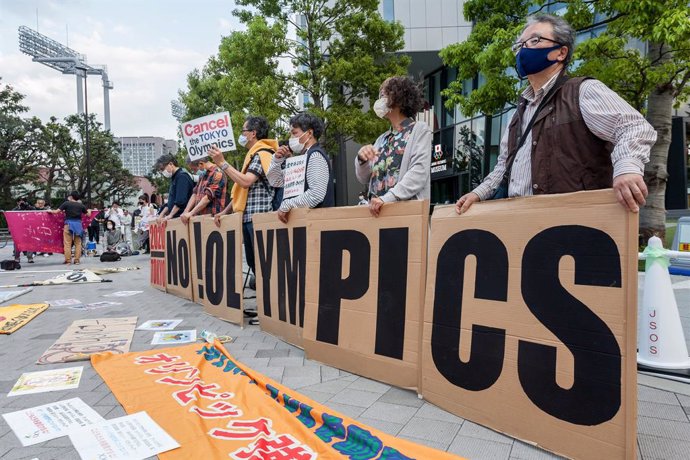 09 May 2021, Japan, Tokyo: Protestors hold signs that spell out "No Olympics" in front of Tokyo's National Stadium, during a protest against hosting the 2020 Summer Olympics. Photo: Damon Coulter/SOPA Images via ZUMA Wire/dpa