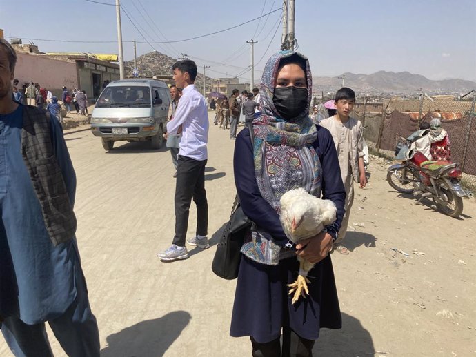 09 May 2021, Afghanistan, Kabul: Hasiba, a 20-year-old Afghan woman walks near the site of the attack, where a car bomb and two mines exploded within minutes of each other not far from the entrance to a school. At  least 50 people were killed and 100 mo