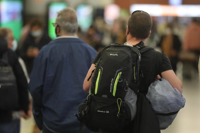 Un hombre camina con su equipaje por la estación de Madrid - Puerta de Atocha, a 14 de mayo de 2021, en Madrid (España). Este viernes comienza el primer fin de semana completo sin el estado de alarma. El final de este marco jurídico, ha supuesto la caíd