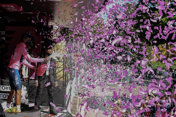 Colombian cyclist Egan Bernal of team Ineos Grenadiers celebrates on the podium in the jersey of the leader in overall classification after the end of the tenth stage of the 104th edition of the Giro d'Italia, 139 km between l'Aquila and Foligno.