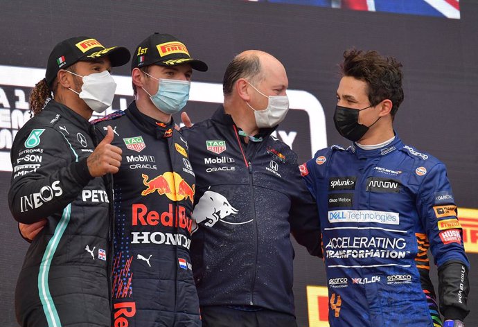 18 April 2021, Italy, Imola: Winning Dutch Formula One driver Max Verstappen of team Red Bull Racing (2nd L), runner-up Brit Lewis Hamilton (L)of Mercedes-AMG Petronas and third-placed Brit Lando Norris from of McLaren F1 Team, celebrate on the podium 