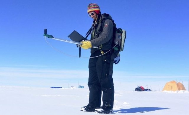 El investigador Gabriel Lewis mide la reflectividad en la capa de hielo de Groenlandia durante una expedición de investigación de 2016.