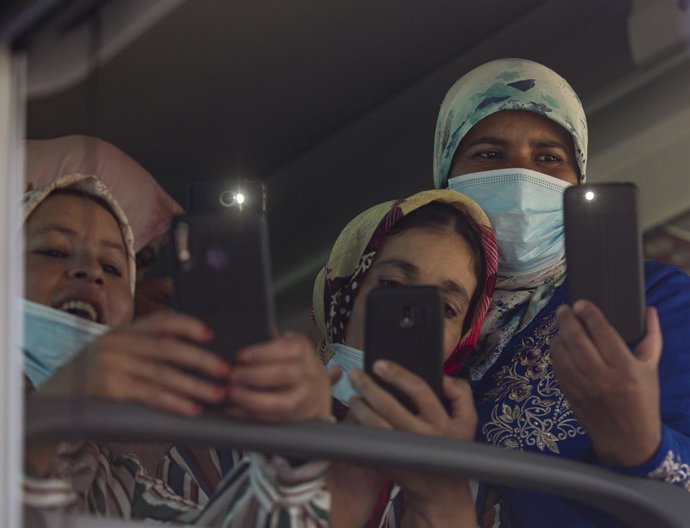 Archivo - Tres temporeras marroquíes en el autobús esperan para entrar al Muelle Sur del Puerto de Huelva para embarcar rumbo a Marruecos el pasado verano, en una imagen de archivo.