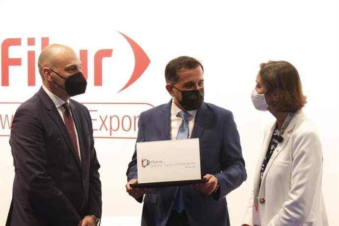 El alcalde de Murcia, José Antonio Serrano y el concejal de Cultura, Turismo y Deportes, Pedro García Rex, han recibido este jueves en Fitur de manos de la ministra de Industria, Comercio y Turismo, María  Reyes Maroto el distintivo