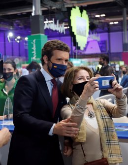 El líder del PP,Pablo Casado, se hace un fotografía con simpatizantes  durante la  visita el pabellón de la Costa del Sol en Fitur-21 a 20 de mayo del 2021, en Madrid, España