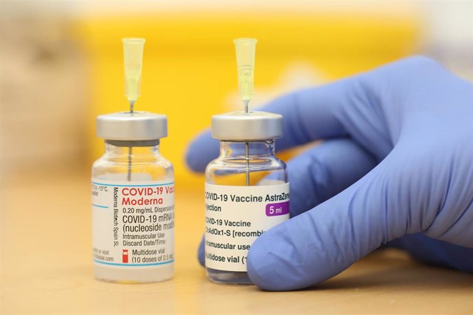 FILED - 13 May 2021, Saxony-Anhalt, Quedlinburg: A health worker holds vials of the coronavirus vaccine from Moderna and AstraZeneca. Japan on Friday approved COVID-19 vaccines from Moderna and AstraZeneca for use in adults amid mounting criticism over 