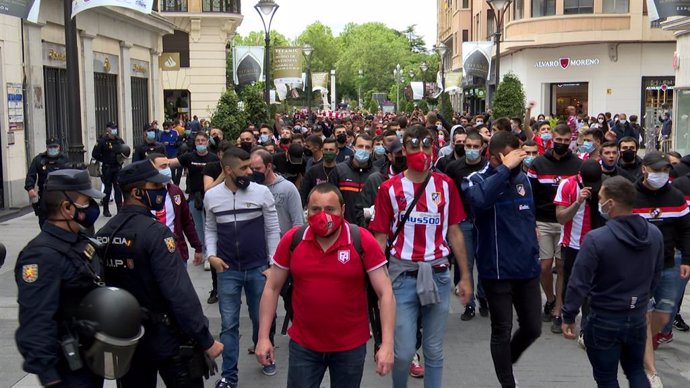 Aficionados del frente Atlético escoltados por agentes de la Policía Nacional a su paso por Valladolid.