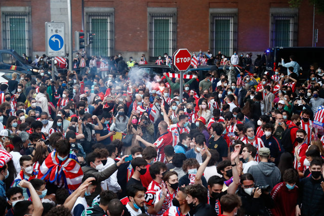 Atletico de Madrid supporters celebrate in Neptuno fount after winning the spanish football championship, La Liga, as Atletico de Madrid won the football match against Real Valladolid on May 22, 2021 in Madrid, Spain.