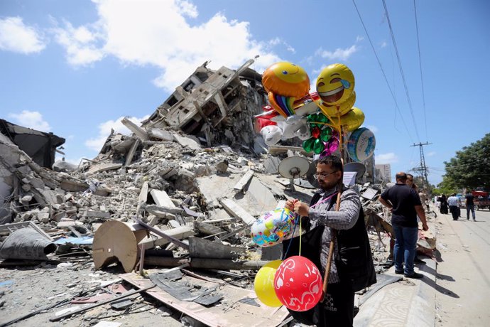 22 May 2021, Palestinian Territories, Gaza: A Palestinian vendor walks past by the ruins of a destroyed building following the Egypt-brokered ceasefire agreement between the Israeli government and the Palestinian Hamas Islamist movement. Photo: Ashraf A