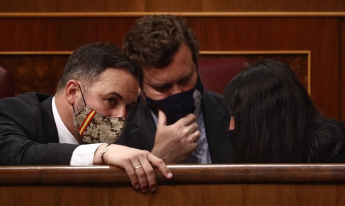 Archivo - (I-D) El líder de Vox, Santiago Abascal; el portavoz parlamentario de Vox, Iván Espinosa de los Monteros; y la portavoz adjunta de Vox en el Congreso, Macarena Olona, conversan durante una sesión plenaria, a 14 de abril de 2021, en el Congreso