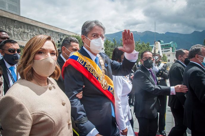 24 May 2021, Ecuador, Quito: Newly elected president of Ecuador Guillermo Lasso (C) leaves the National Assembly with his wife Lourdes Alcivar wearing the presidential scarf after his inauguration. Photo: Juan Diego Montegro/