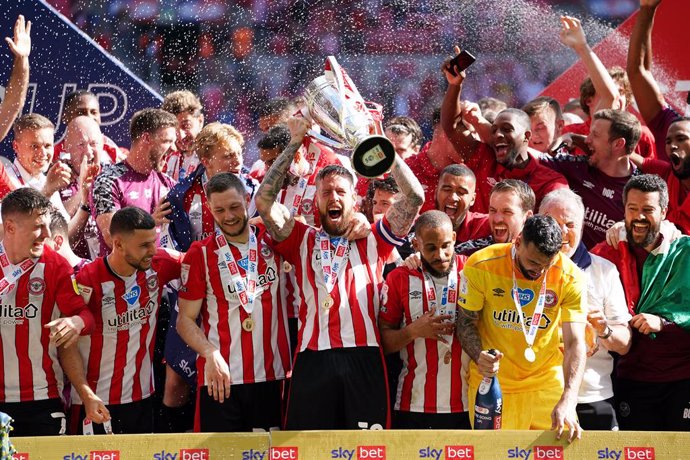 29 May 2021, United Kingdom, London: Brentford's Pontus Jansson (C) lifts the trophy as they celebrate promotion to the Premier League after winning the English EFL Championship play-offs final soccer match between Brentford and Swansea City at Wembley 