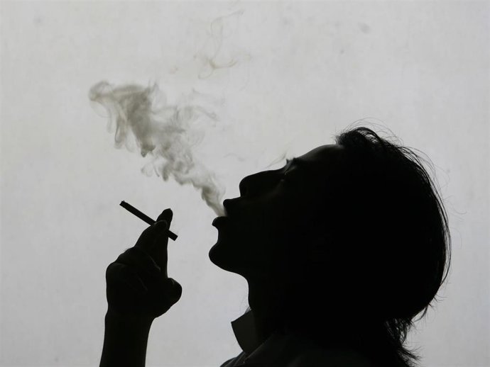 Archivo - In this photo illustration a man exhales smoke whilst smokign a cigarette on World No Tobacco Day