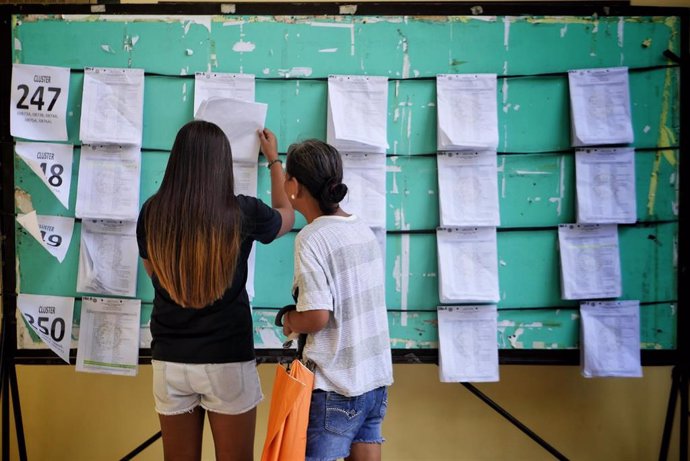 Archivo - Ciudadanos en Filipinas comprueban sus nombres en la lista de un colegio electoral durante las elecciones locales de 2019.