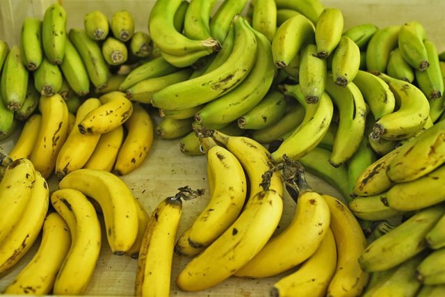 Archivo - Manojo de plátanos en un mercado de Madird.