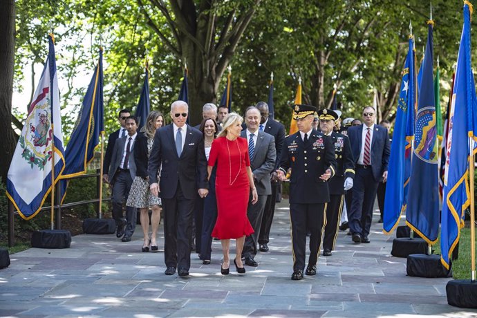 31 May 2021, US, Arlington County: USPresident Joe Biden (L) walks with First Lady Jill and US Army Major General Omar J. Jones IV (R) for the National Memorial Day Observance at Arlington National Cemetery, Virginia in the presence of  Vice President 