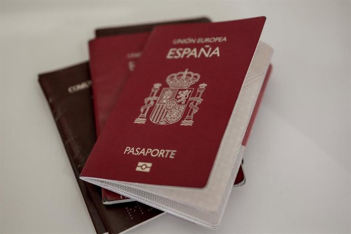 Archivo - Varios pasaportes españoles colocados sobre una mesa.