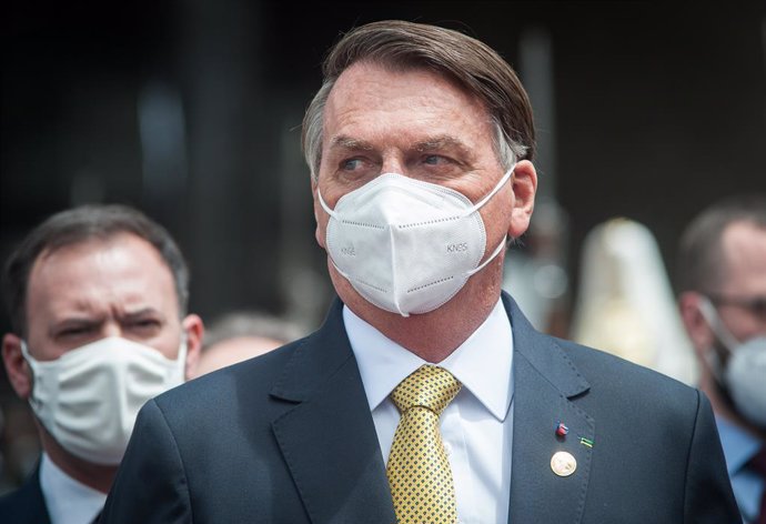 24 May 2021, Ecuador, Quito: Brazilian President Jair Bolsonaro leaves the National Assembly wearing a mask after the inauguration of the president of Ecuador Guillermo Lasso. Photo: Juan Diego Montegro/