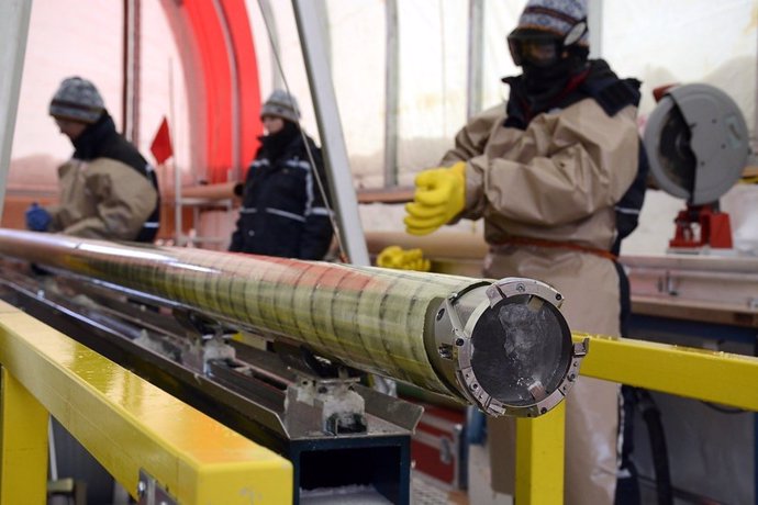 Perforadores de hielo con un núcleo de hielo recién perforado en el proyecto de núcleo de hielo del Polo Sur (SPICEcore).