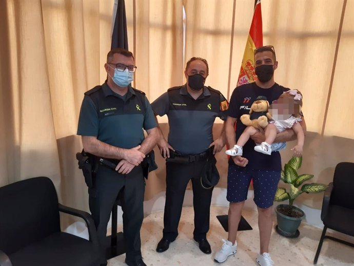 Agentes de la Guardia Civil, con la bebé auxiliada cuando se ahogaba en una piscina en Mairena del Alcor, Sevilla