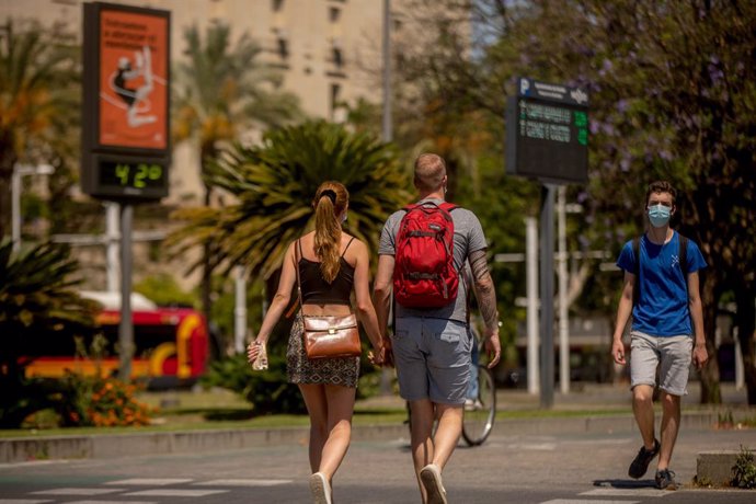 Turistas pasean por el centro de Sevilla.