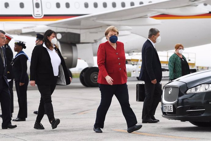 11 June 2021, United Kingdom, Newquay: German Chancellor Angela Merkel (C) arrives at Cornwall Airport Newquay to attend the G7 summit, that will be held from 11 to 13 June. Photo: Stefan Rousseau/PA Wire/dpa