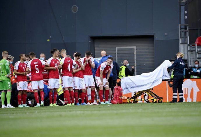 12 June 2021, Denmark, Copenhagen: Denmark's Christian Eriksen leaves the pitch on a stretcher after collapsing during the UEFA Euro 2020 Group B soccer match between Finland and Denmark at the Parken Stadium. Photo: Markku Ulander/Lehtikuva/dpa