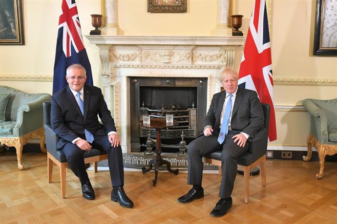 15 June 2021, United Kingdom, London: UK Prime Minister Boris Johnson (R) speaks with Australian Prime Minister Scott Morrison during their meeting to formally announce a joint trade deal at 10 Downing Street. It will be the UK's first trade deal negoti