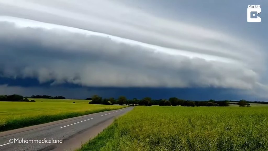 Pair of storm chasers video capture shelf cloud formation in Denmark