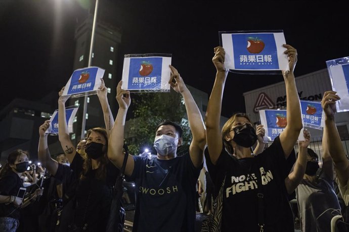 23 June 2021, China, Hong Kong: Supporters hold placards of the Apple Daily newspaper logo in front of the Pro-democracy newspaper Apple Daily. Hong Kong's strong advocate for democracy for 26 years is forced to end it's business tonight under the polit