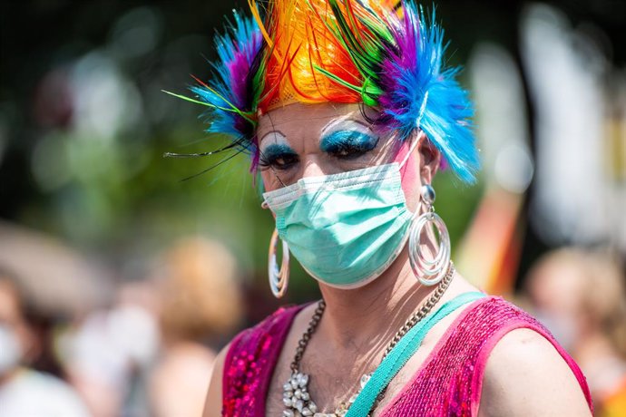 26 June 2021, Berlin: A participant in colorful costume and wig, takes part in the Christopher Street Day (CSD Berlin Pride) parade. Hundreds of people attended pride parades in Berlin on Saturday to demand equal rights for gay, lesbian, bisexual and tr