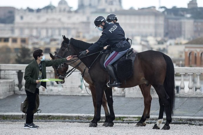Archivo - 16 March 2021, Italy, Rome: Two policemen of the equestrian squad ride check papers of a person in the park of the Villa Borghese. Photo: Roberto Monaldo/LaPresse via ZUMA Press/dpa