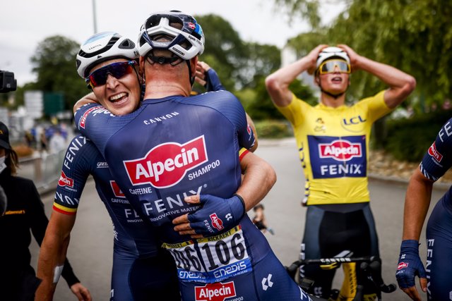 Belgian cyclist Tim Merlier of Alpecin-Fenix, celebrates winning the race with Jasper Philipsen and Mathieu van der Poel of Alpecin-Fenix after the end of the third stage of the Tour de France, 182.9 km from Lorient to Pontivy.
