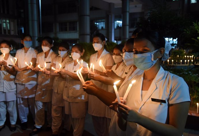 01 July 2021, India, Guwahati: Nurses attend a candlelight ceremony to pay a tribute to the doctors who died because of the coronavirus (COVID-19) on the occasion of the National Doctors' Day in India. Photo: Dasarath Deka/ZUMA Wire/dpa