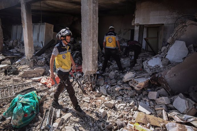 03 July 2021, Syria, Sahl ar Ruj: Members of the Syria Civil Defence, known as White Helmets, inspect the rubble of a damaged Civil Defence centre after it was targeted by warplanes. According to a war monitor, Russian aircraft allegedly carried out the