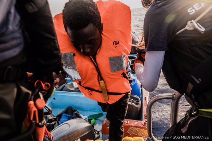 HANDOUT - 04 July 2021, Italy, ---: A migrant is helped out of a small boat. The Ocean Viking rescue vessel has pulled 67 people from the central Mediterranean Sea, SOS Mediterranee the private organization that runs the vessel, said on Sunday. Photo: F