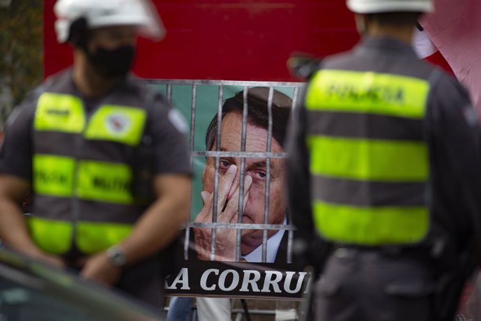 03 July 2021, Brazil, Sao Paulo: A banner with the photo of President Jair Bolsonaro in prison is seen during a protest on Paulista avenue against President Jair Bolsonaro's coronavirus policies after the Supreme Court allowed investigations to be opene