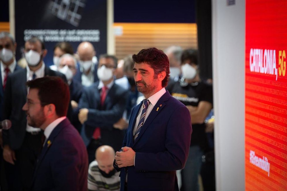 El vicepresident del Govern de la Generalitat de Cataluña, Jordi Puigneró (d), durante su visita al stand de Cataluña en la primera jornada de la XIV edición del Mobile World Congress (MWC 2021) en el recinto Gran Via de Fira de Barcelona, en L'Hospital