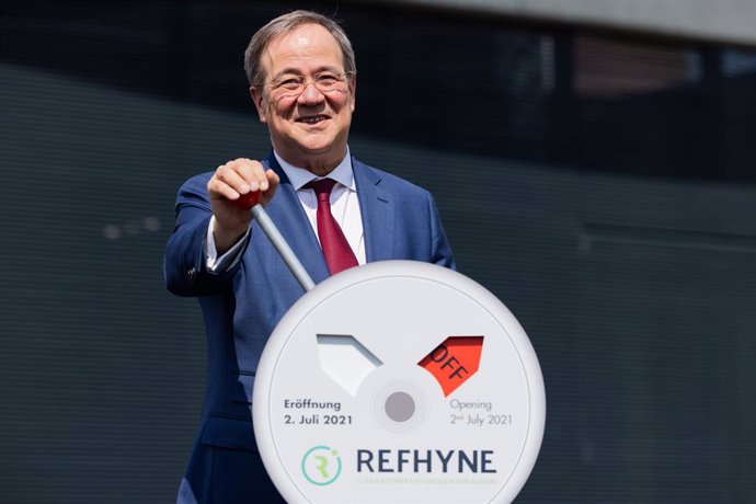 02 July 2021, North Rhine-Westphalia, Wesseling: Armin Laschet, Minister President of North Rhine-Westphalia and CDU candidate for chancellor, symbolically flips a switch during Shell's commissioning of Europe's largest PEM green hydrogen electrolyser. 