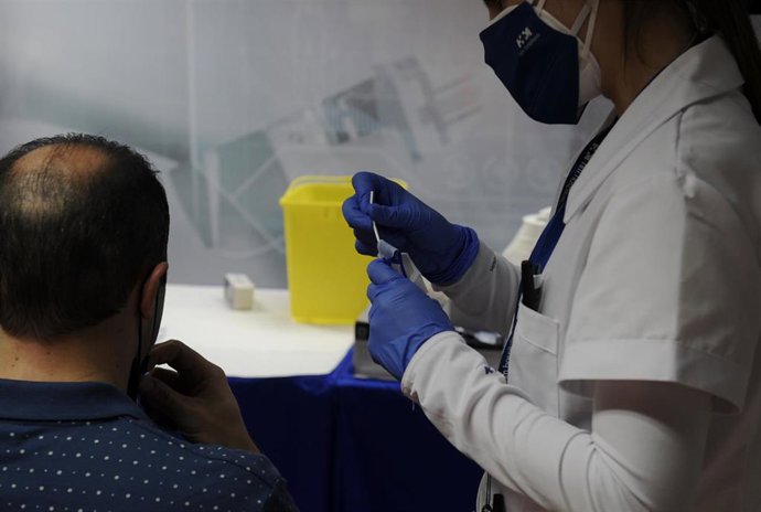 Una sanitaria realiza un test de antígenos a un hombre. 