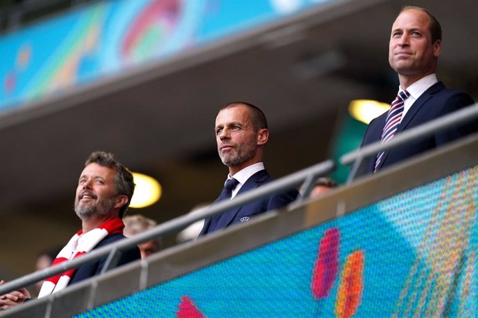 07 July 2021, United Kingdom, London: (L-R) The Crown Prince Frederik of Denmark, UEFA president Aleksander Ceferin and Prince William, Duke of Cambridge, sit in the stands during the UEFA Euro 2020 semi-final soccer match between England and Denmark at