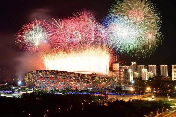 Photo shows fireworks explode over the National Stadium. (Photo by Xinhua News Agency)