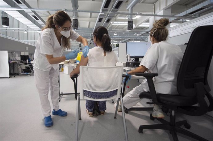 Una joven recibe la primera dosis de la vacuna Pfizer en el Hospital Zendal el día que comienza la vacunación a jóvenes madrileños a partir de 16 años, a 13 de julio de 2021, en Madrid (España).